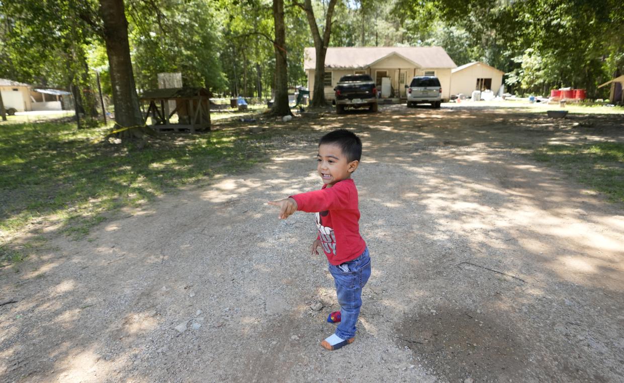 Josue Barcenas plays in his driveway, Sunday, April 30, 2023, across the street from the scene of a mass shooting Friday night, in Cleveland, Texas. The search for a Texas man who allegedly shot his neighbors after they asked him to stop firing off rounds in his yard stretched into a second day Sunday, with authorities saying the man could be anywhere by now. Francisco Oropeza, 38, fled after the shooting Friday night that left five people dead, including a young boy. (AP Photo/David J. Phillip)