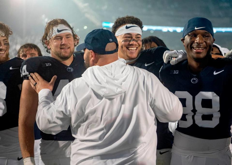 Penn State tight ends coach Ty Howl celebrates with Tyler Warren and Theo Johnson after the win over Iowa on Saturday, Sept. 23, 2023.