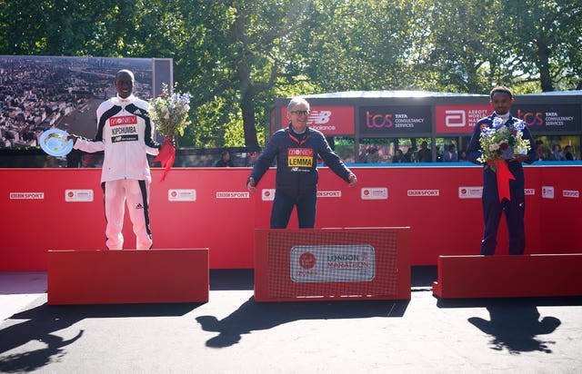 Agent Gianni Demadonna (centre) on the top spot of the podium on behalf of winner Sisay Lemma