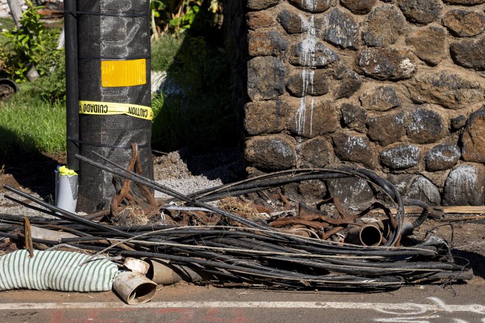 Burned wires and PVC pipes sit on the side of the road in Lahaina, Hawaii, after a devastating wildfire in 2023. <a href="https://newsroom.ap.org/detail/HawaiiWildfire/756e559e0e054a2099908850fc18495b/photo" rel="nofollow noopener" target="_blank" data-ylk="slk:AP Photo/Lindsey Wasson;elm:context_link;itc:0;sec:content-canvas" class="link ">AP Photo/Lindsey Wasson</a>