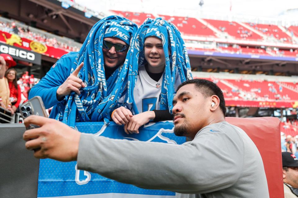 Detroit Lions offensive tackle Penei Sewell takes a selfie with Zach Kelsey and his son Sawyer, 13, both of 
Twin falls, Idaho, during warm up before the NFC championship game against San Francisco 49ers at Levi's Stadium in Santa Clara, Calif. on Sunday, Jan. 28, 2024.