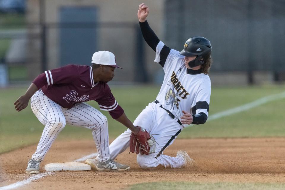 Alabama State catcher Hunter May (5) steals third with Alabama A&M infielder Tommy Easley (4) covering the base during an NCAA baseball game on Saturday, April 9, 2022, in Montgomery, Ala. (AP Photo/Vasha Hunt)