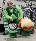 A street performer dressed as a leprechaun smokes a cigarette as he takes a break in Dublin, Ireland.