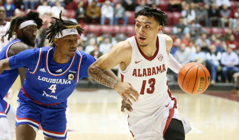 Alabama guard Jahvon Quinerly (13) drives to the baseline with Louisiana Tech guard Amorie Archibald Louisiana Tech guard Kaleb Stewart (4) defending during the season opening game in Coleman Coliseum Tuesday, Nov. 9, 2021. [Staff Photo/Gary Cosby Jr.]