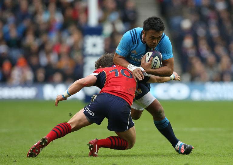 Scotland's Peter Horne (L) tackles Italy's Kelly Haimona during their Six Nations match at Murrayfield in Edinburgh, Scotland on February 28, 2015