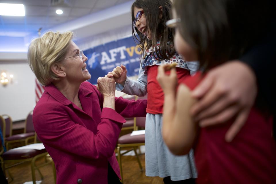 Democratic presidential hopeful Elizabeth Warren pinky-swears with Rebecca Buse-Morley, 8, at a May 13 American Federation of Teachers event. (Photo: Mark Makela via Getty Images)