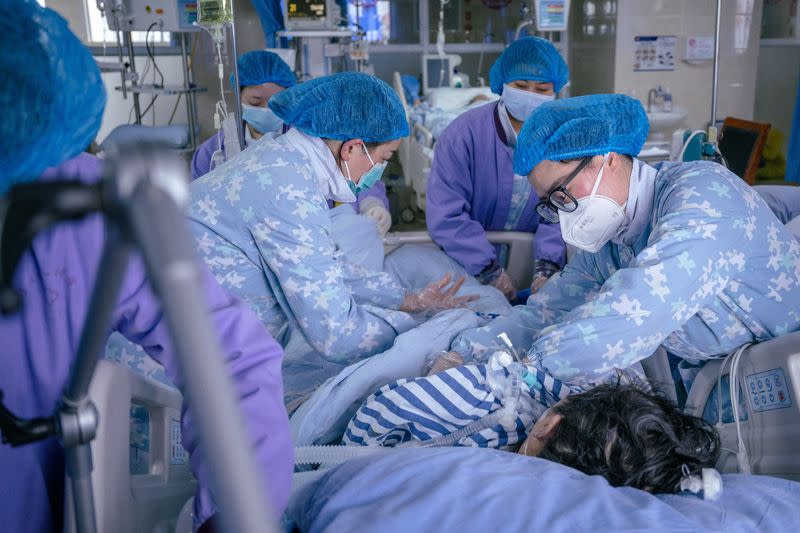 Medical workers rescue a patient at a hospital in Meishan