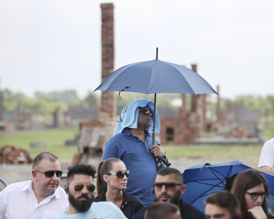 People gather to commemorate the Roma and Sinti people killed by Nazi Germany in World War II, during ceremonies at Oswiecim, Poland, Friday Aug. 2, 2019. The American civil rights activist Rev. Jesse Jackson gathered Friday with survivors at the former Nazi death camp of Auschwitz-Birkenau to commemorate an often forgotten genocide — that of the Roma people. (AP Photo/Czarek Sokolowski)