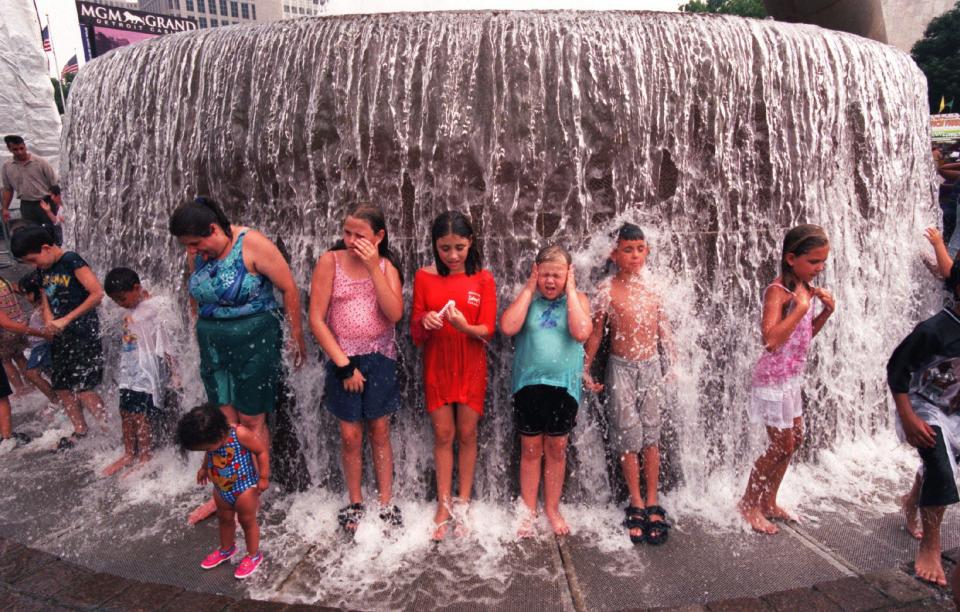 Kids play in the water fountain in Hart Plaza during the Detroit 300 celebration in July 2001.