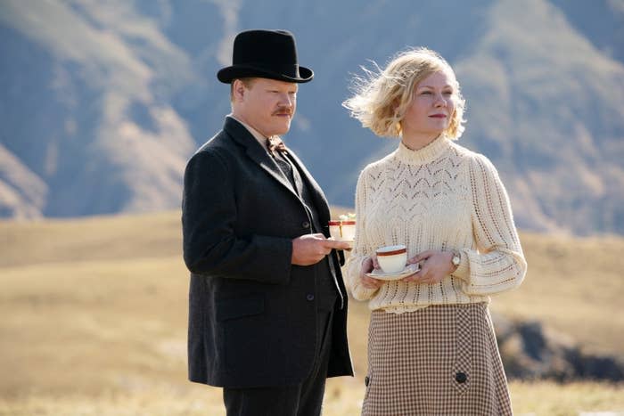 Jesse Plemons and Kirsten Dunst hold cups of tea together in a scene from the film