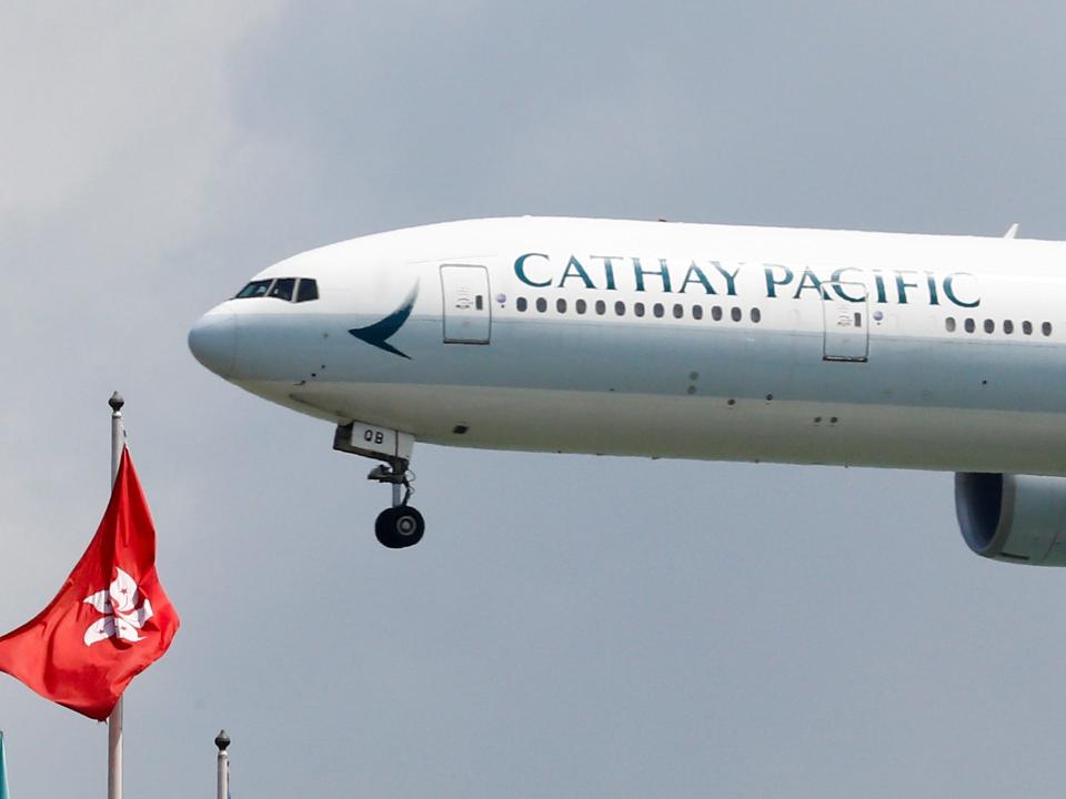 FILE PHOTO: FILE PHOTO: A Cathay Pacific Boeing 777-300ER plane lands at Hong Kong, China August 14, 2019. REUTERS/Thomas Peter