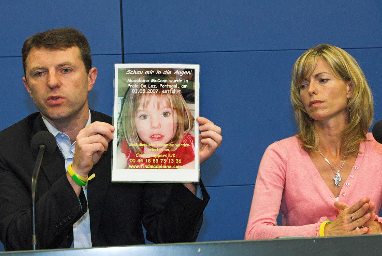 Gerry, left, and Kate McCann, parents of four-year old Madeleine McCann, missing from the Portuguese town of Praia Da Luz since May, present a picture of their daughter during a press conference in Berlin, Wednesday, June 6, 2007.  The parents of a British girl who disappeared in Portugal appealed Wednesday to German tourists for help in their search for their kidnapped 4-year-old daughter. (AP Photo/Sven Kaestner)
