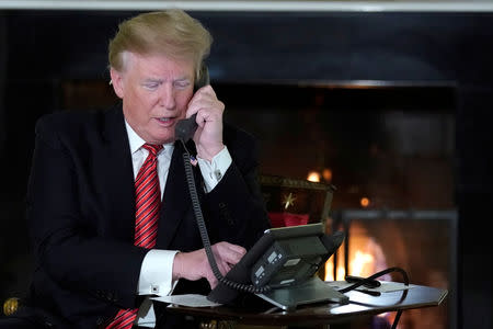 U.S. President Donald Trump participates in NORAD Santa tracker phone calls from the White House in Washington, U.S. December 24, 2018. REUTERS/Jonathan Ernst