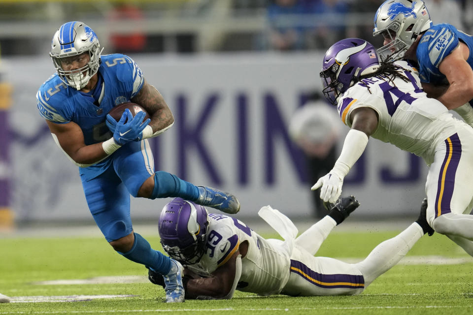 Detroit Lions running back David Montgomery (5) breaks a tackle by Minnesota Vikings linebacker Danielle Hunter (99) during the first half of an NFL football game, Sunday, Dec. 24, 2023, in Minneapolis. (AP Photo/Abbie Parr)