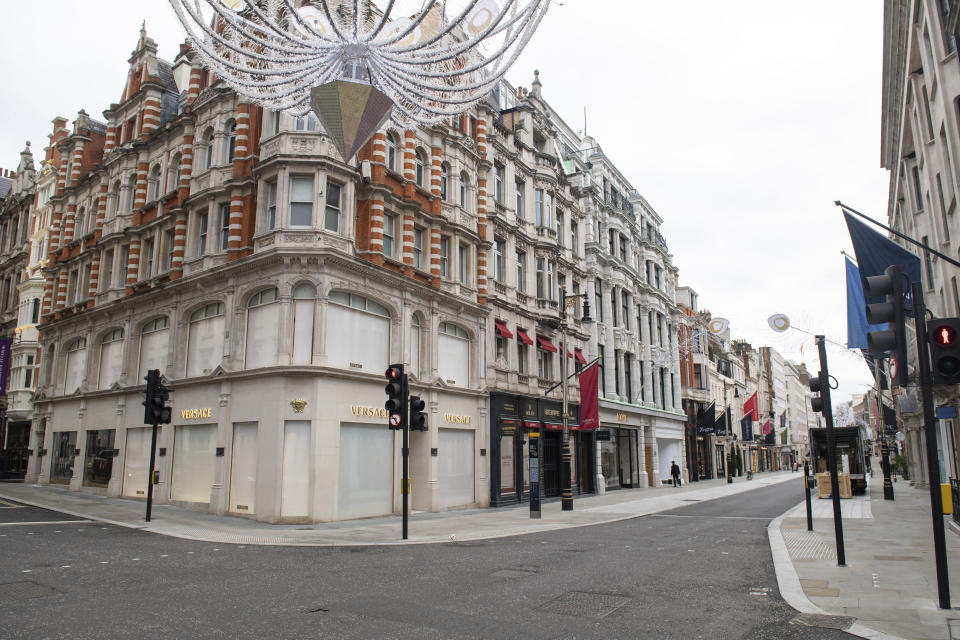 A general view of closed shops on an empty New Bond Street, as England continues a four week national lockdown to curb the spread of coronavirus, in London, Tuesday, Nov. 17, 2020. (Dominic Lipinski/PA via AP)