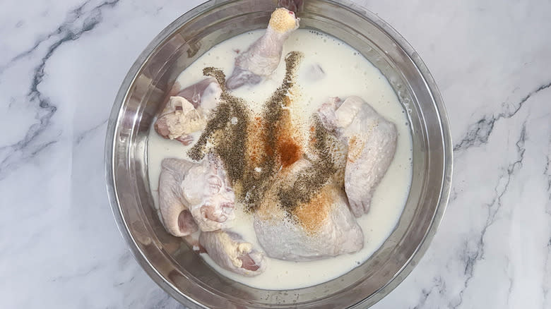 chicken, milk, seasonings in bowl