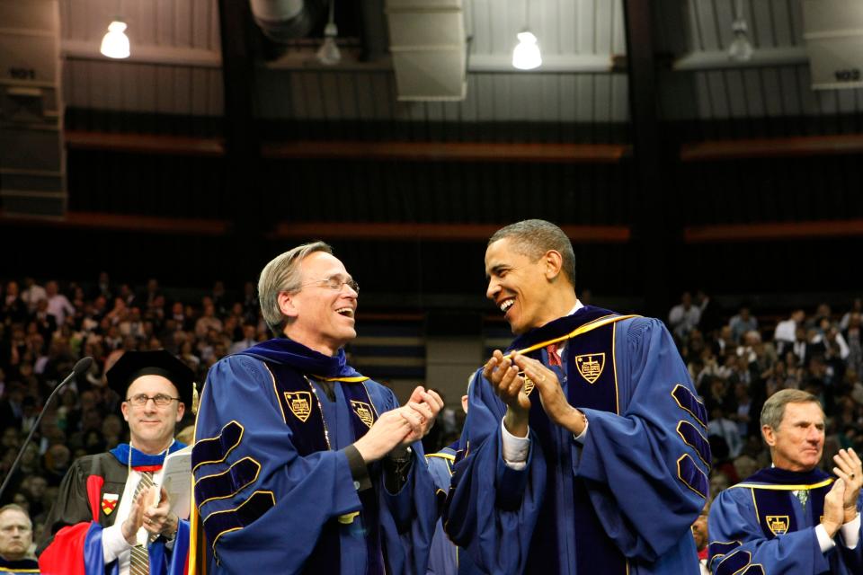 The Rev. John I. Jenkins and President Barack Obama share a laugh during the University of Notre Dame's commencement ceremony Sunday, May 17, 2009, at the Joyce Center in South Bend.