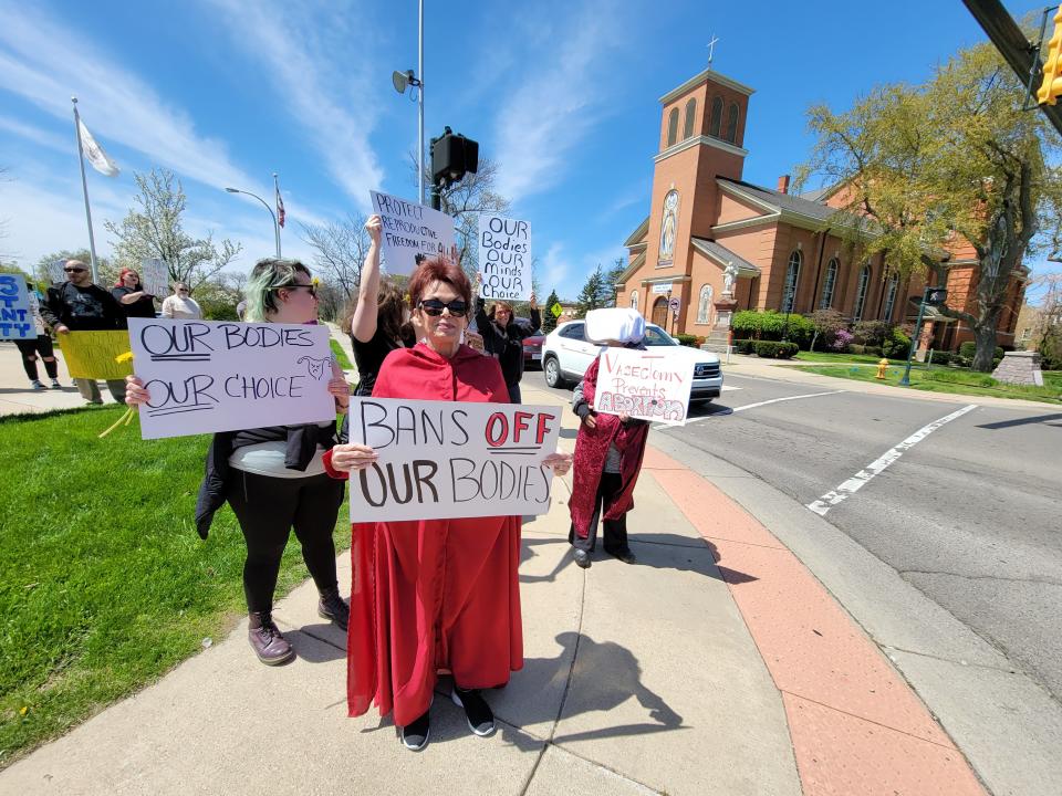 Pro-choice protestors gathered at the City of Monroe's Gen. George Armstrong Custer Monument Sunday to protest the U.S. Supreme Court's potential overruling of Roe v. Wade. Some of the protestors wore costumes inspired by "The Handmaid's Tale" book and television series.