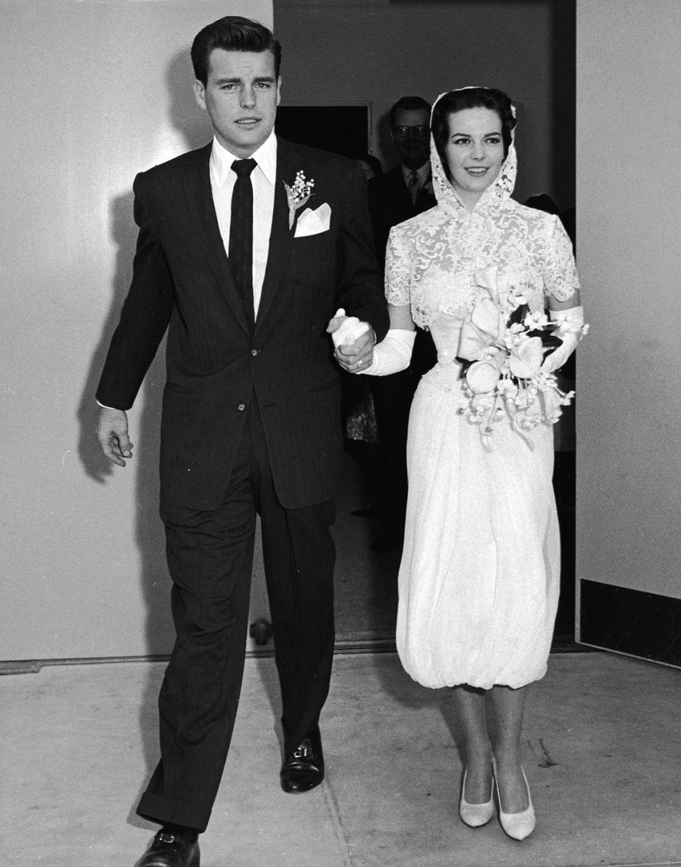 <p>For her first marriage to Robert Wagner in 1957 (the two would remarry in 1972), Natalie Wood opted for a modern look that included a white strapless cocktail dress, a lace hood, and ballet flats. </p>