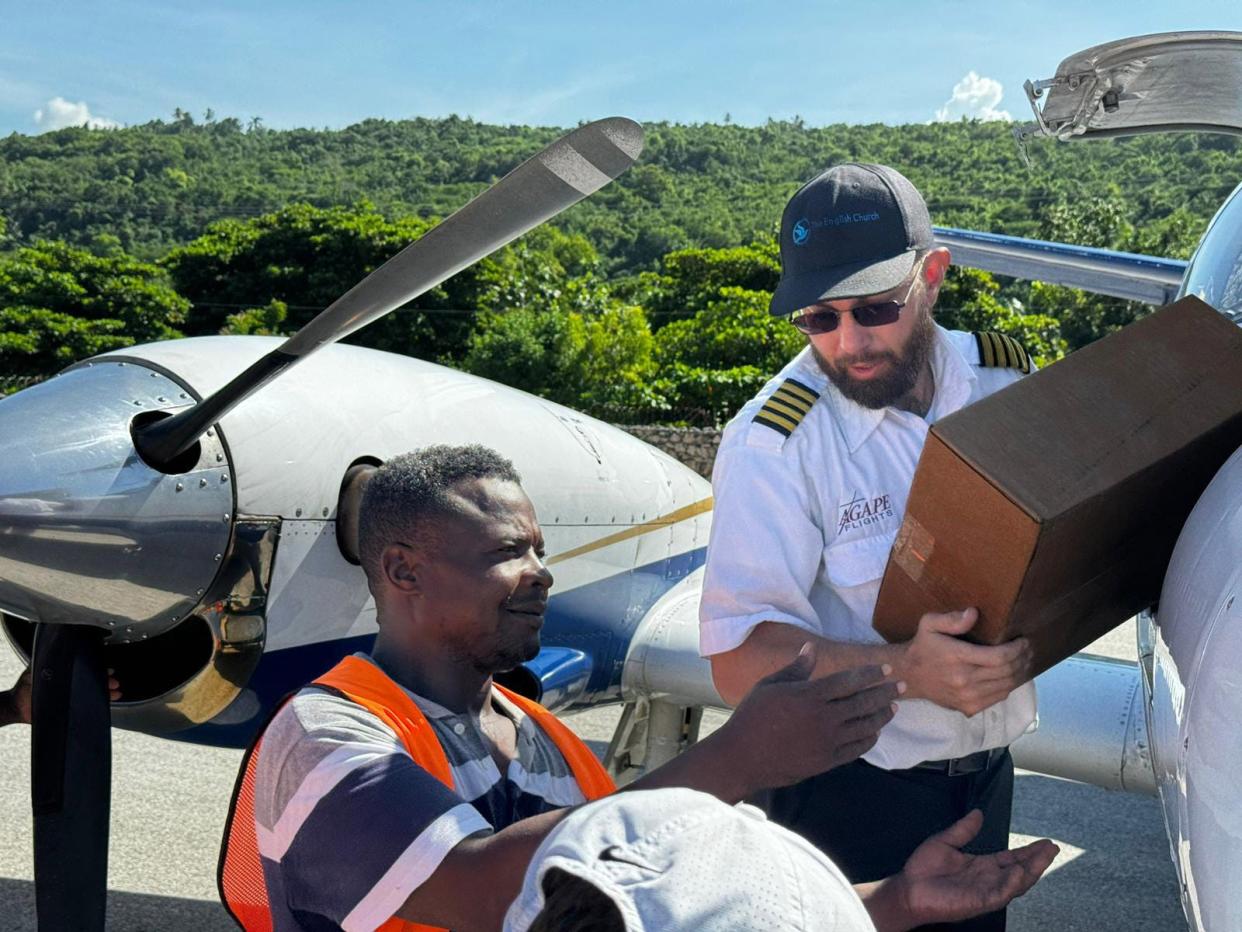 Agape Flights pilot Greg Haman unloads cargo from the organization’s Cessna F406 recently in Jeremie, Haiti.