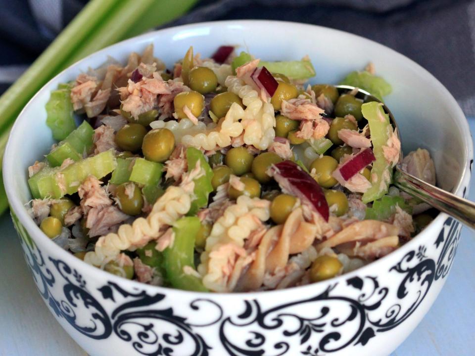 tuna salad in a black and white bowl on a white table