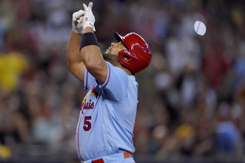 The St. Louis Cardinals' Albert Pujols points skyward after he homered during the fourth inning Aug. 20, 2022.