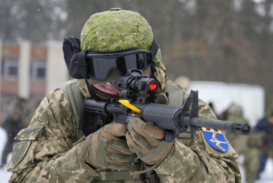 A member of Ukraine's Territorial Defense Forces, volunteer military units of the Armed Forces, trains close to Kyiv, Ukraine, Saturday, Feb. 5, 2022. Hundreds of civilians have been joining Ukraine's army reserves in recent weeks amid fears about a Russian invasion. (AP Photo/Efrem Lukatsky)