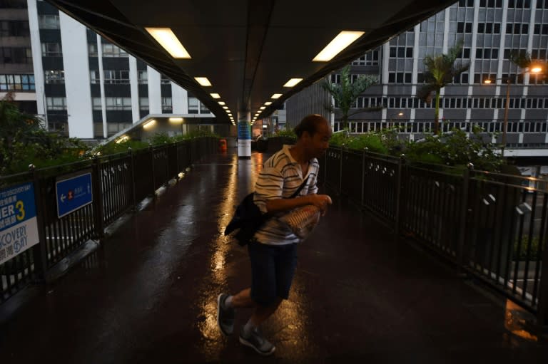 A man tries to walk against the wind from Typhoon Hato as Hong Kong's weather observatory raised the storm warning to the city's highest Typhoon 10 signal -- the first such alert in five years