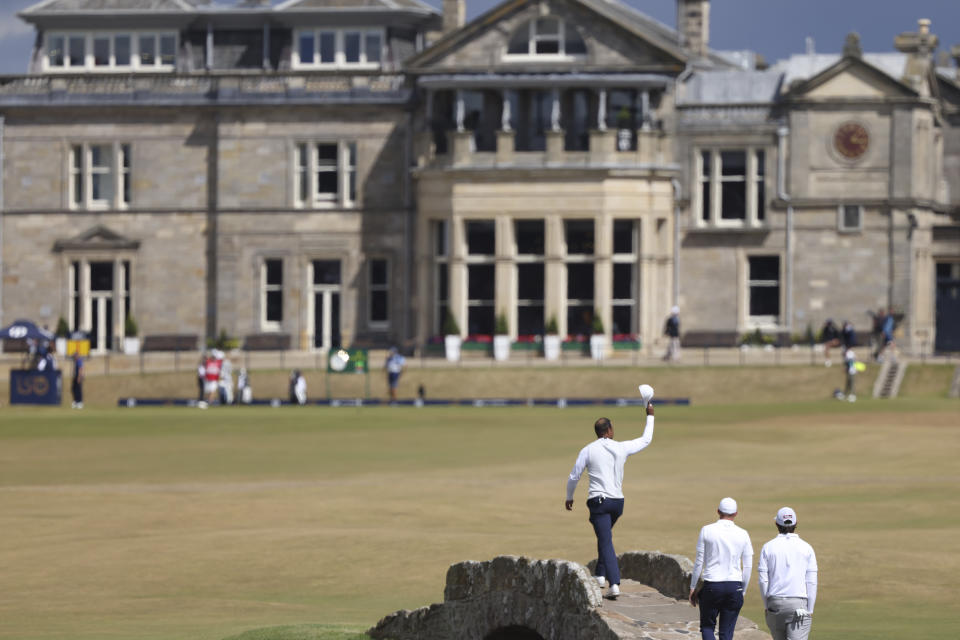 Tiger Woods of the US gestures to the crowd at the end of his second round of the British Open golf championship on the Old Course at St. Andrews, Scotland, Friday July 15, 2022. The Open Championship returns to the home of golf on July 14-17, 2022, to celebrate the 150th edition of the sport's oldest championship, which dates to 1860 and was first played at St. Andrews in 1873. (AP Photo/Peter Morrison)