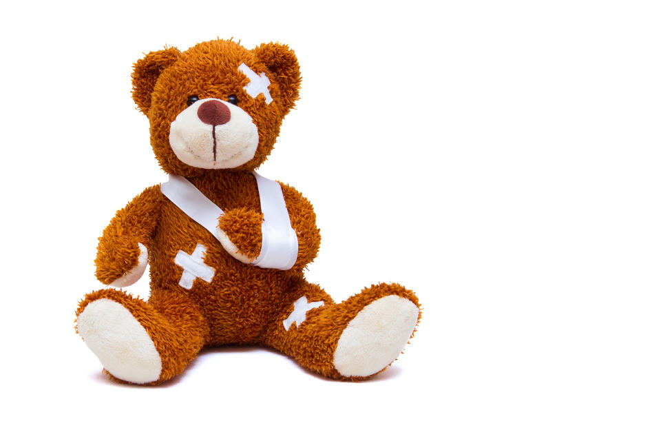 Injured teddy bear with a sling and some bandages