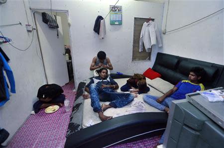 Rohingya men rest in a rented house in Cheras Baru, Kuala Lumpur March 2, 2014. REUTERS/Samsul Said