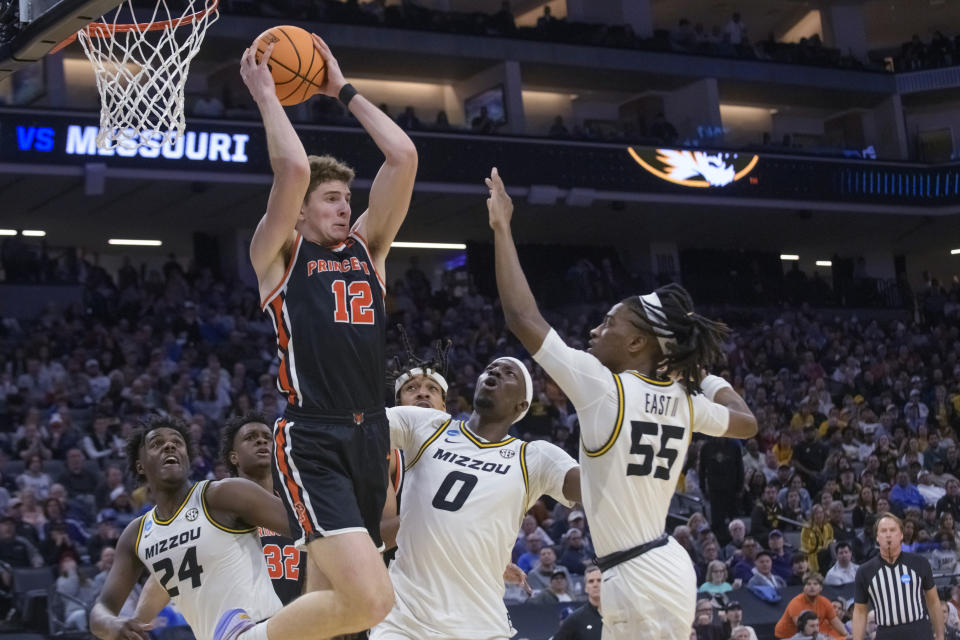 Princeton forward Caden Pierce (12) grabs a rebound over Missouri guard Kobe Brown (24), forward Mohamed Diarra (0) and guard Sean East II (55) during the second half of a second-round college basketball game in the men's NCAA Tournament in Sacramento, Calif., Saturday, March 18, 2023. Princeton won 78-63. (AP Photo/Randall Benton)