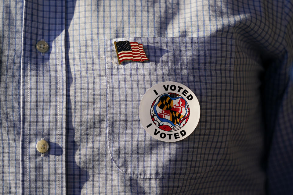 Dan Cox, Republican gubernatorial candidate in Maryland, wears a pin and a sticker after casting his vote at Sabillasville Elementary School, Tuesday, Nov. 8, 2022, in Sabillasville, Md. (AP Photo/Julio Cortez)