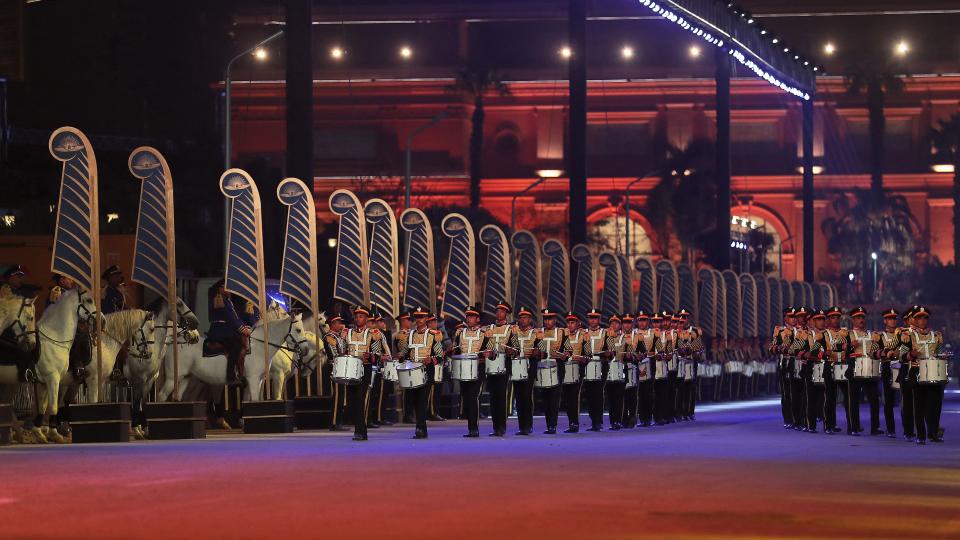 A marching band marches at the start of the parade of 22 ancient Egyptian royal mummies departing from the Egyptian Museum in Cairo's Tahrir Square on April 3, 2021, on their way to their new resting place at the new National Museum of Egyptian Civilisation (NMEC) about seven kilometres south in historic Fustat (Old Cairo). - Dubbed the Pharaohs' Golden Parade, the 18 kings and four queens will travel in order, oldest first, each aboard a separate float decorated in ancient Egyptian style. (Photo by Mahmoud KHALED / AFP) (Photo by MAHMOUD KHALED/AFP via Getty Images)