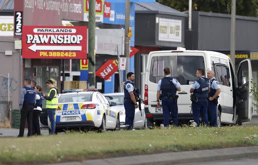 Police stand outside a mosque after the shooting. (AP)