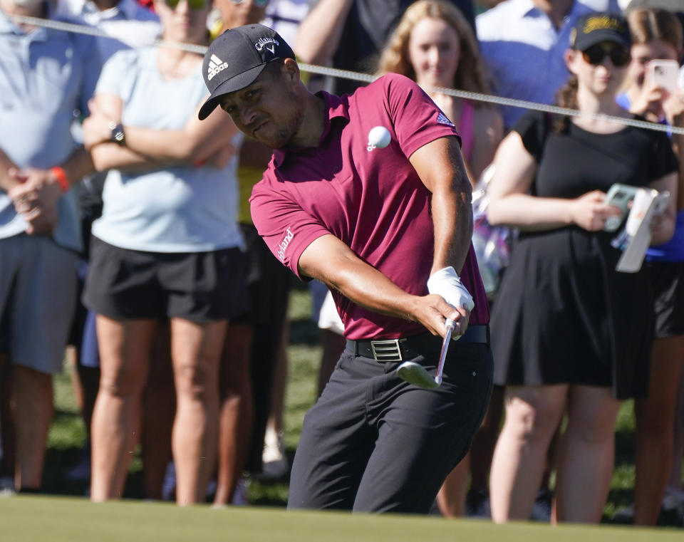 Xander Schauffele hits up on the ninth hole during the second round of the Phoenix Open golf tournament Friday, Feb. 11, 2022, in Scottsdale, Ariz. (AP Photo/Darryl Webb)