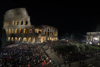 A view of the Colosseum, lit ahead of Pope Francis arrival for the Via Crucis (Way of the Cross) torchlight procession on Good Friday, a Christian holiday commemorating the crucifixion of Jesus Christ and his death at Calvary, in front of Rome's Colosseum, in Rome, Friday, April 19, 2019. (AP Photo/Andrew Medichini)