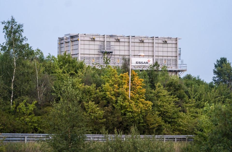 The load towers over a line of trees as it is moved towards the M53 (Danny Lawson/PA) (PA Wire)