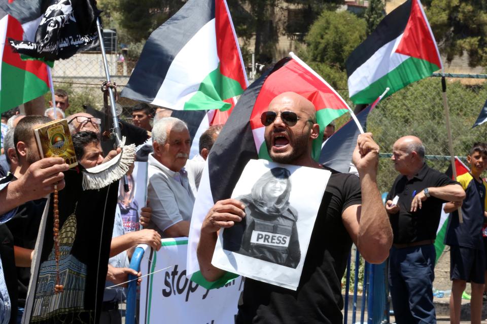 A man holds a photo of slain Palestinian-American journalist Shireen Abu Akleh during a protest at Dheisheh refugee camp, near Bethlehem (EPA)
