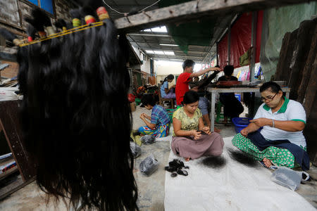 Workers clean the hair for export at Tet Nay Lin Trading Co. in Yangon, Myanmar, June 19, 2018. Picture taken June 19, 2018. REUTERS/Ann Wang