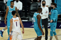 Phoenix Suns guard Devin Booker (1) has words with Charlotte Hornets guard LaMelo Ball, right, during the second half of an NBA basketball game, Wednesday, Feb. 24, 2021, in Phoenix. Booker was given a technical foul for the confrontation. (AP Photo/Matt York)