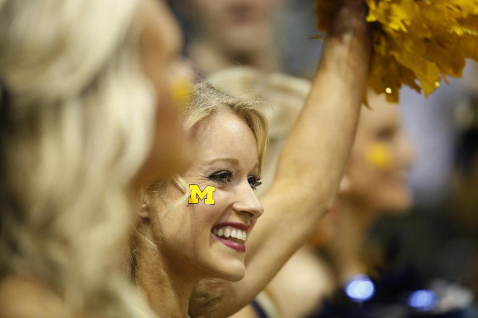 Michigan cheerleaders perform during the first half of a second round NCAA college basketball tournament game between the Michigan and the Wofford Thursday, March 20, 2014, in Milwaukee. (AP Photo/Jeffrey Phelps)
