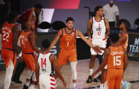 Phoenix Suns guard Devin Booker (1) celebrates with teammates in the first half of an NBA basketball game against the Washington Wizards in Lake Buena Vista, Fla., Friday, July 31, 2020. (Kim Klement/Pool Photo via AP)