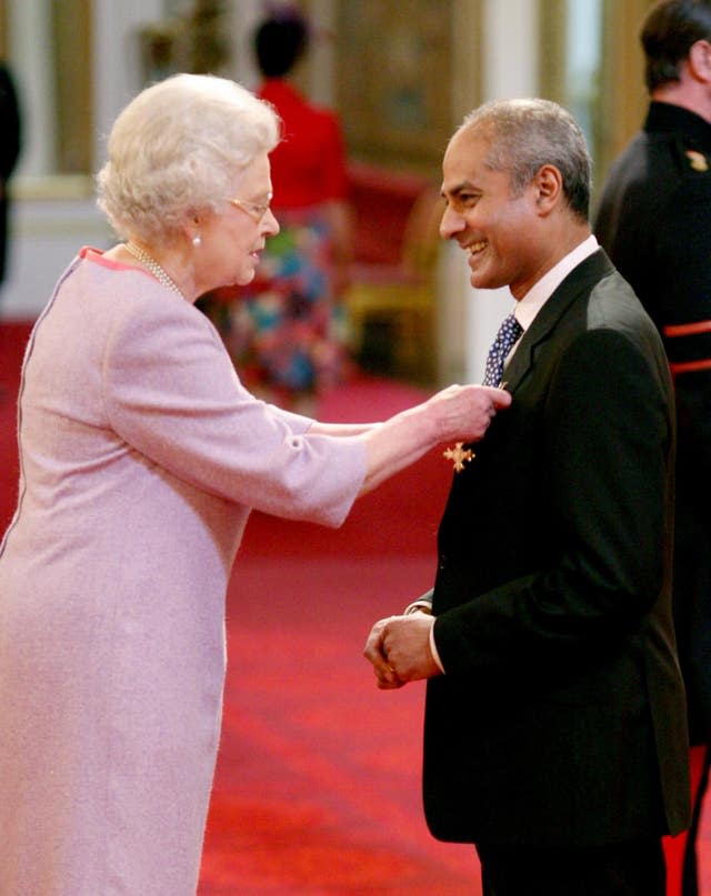 George Alagiah being made an OBE by the Queen at Buckingham Palace