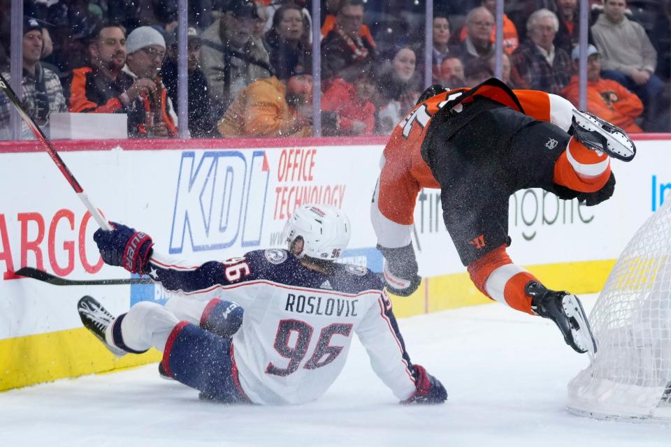 Philadelphia Flyers' Owen Tippett, right, and Columbus Blue Jackets' Jack Roslovic collide during overtime in an NHL hockey game, Thursday, Jan. 4, 2024, in Philadelphia. (AP Photo/Matt Slocum)