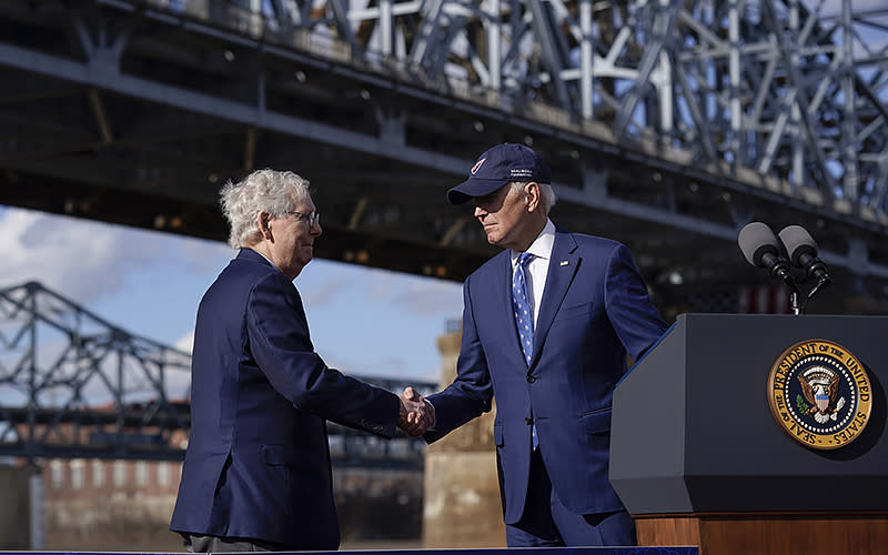 President Biden shakes hands with Senate Minority Leader Mitch McConnell (R-Ky.) after speaking about his infrastructure agenda under the Clay Wade Bailey Bridge, on Jan. 4 in Covington, Ky. A<em>ssociated Press/Patrick Semansky</em>