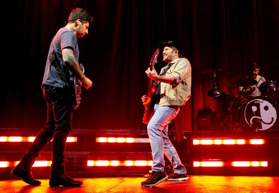 Fall Out Boy’s Joe Trohman (left) and Pete Stump jam on stage during their concert at Raleigh, N.C.’s PNC Arena, Tuesday night, March 19, 2024.