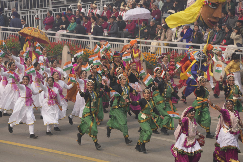 School children in traditional outfits run with Indian flags at the ceremonial Kartavya Path boulevard during India's Republic Day parade celebrations in New Delhi, India, Friday, Jan. 26, 2024. (AP Photo/Manish Swarup)