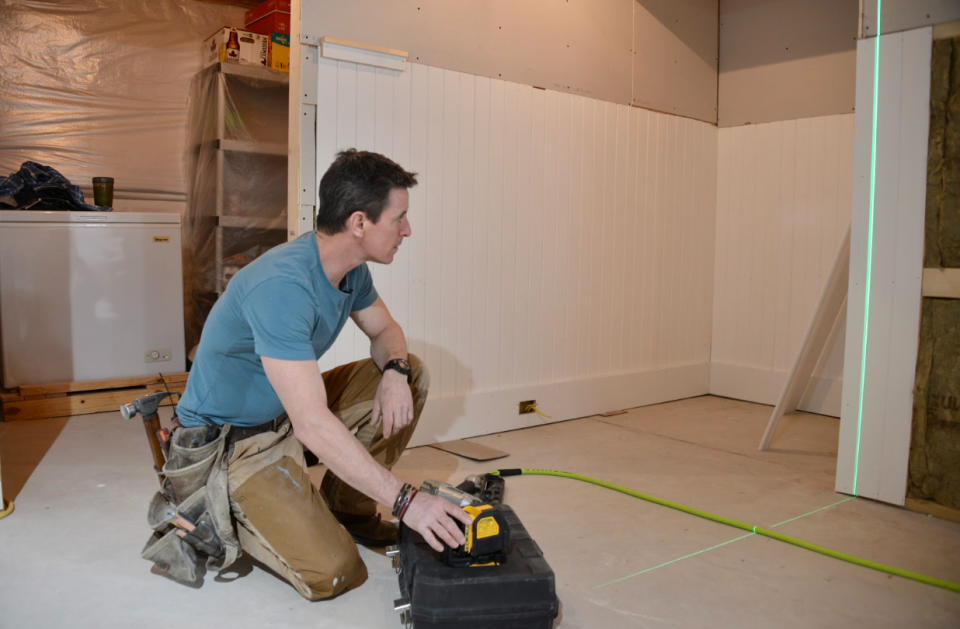 Using a laser level makes it easier to lay out and level a beadboard wall. 