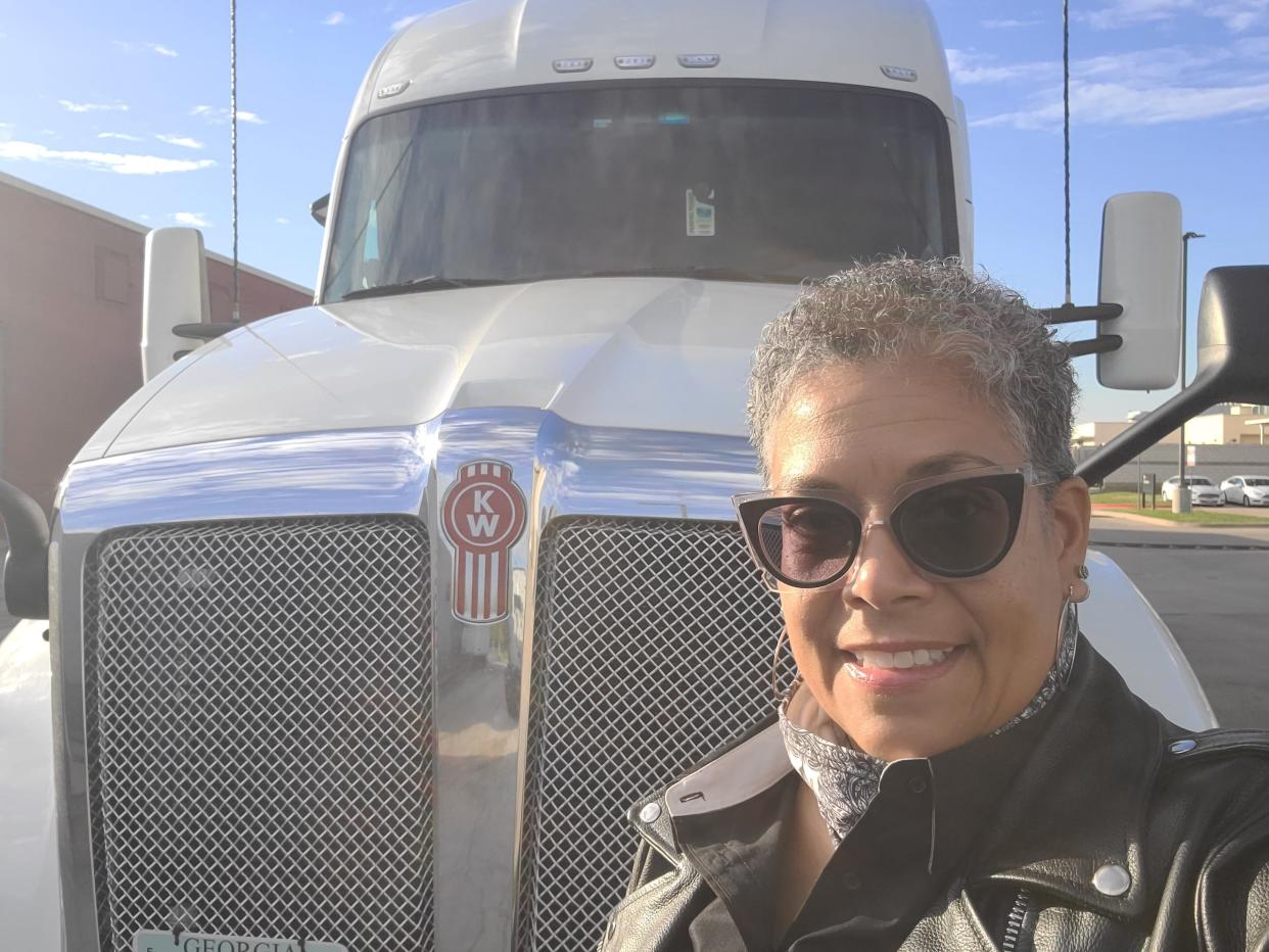 Vanita Johnson, a truck driver based in Atlanta, Georgia, takes a selfie with her white truck.